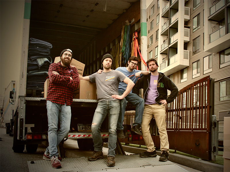 Broad Street Movers employees skillfully and carefully unloading a truck into a new home for an apartment moving job.